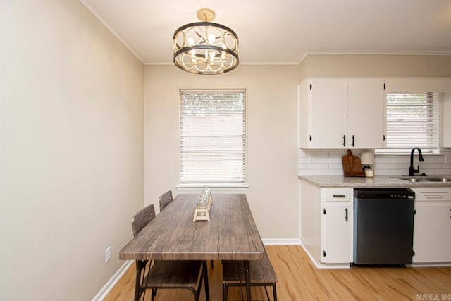 kitchen with sink, dishwashing machine, light hardwood / wood-style floors, and tasteful backsplash