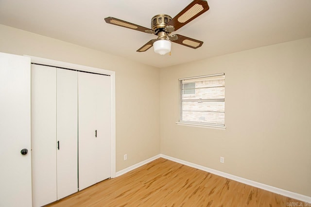 unfurnished bedroom featuring light hardwood / wood-style flooring, a closet, and ceiling fan