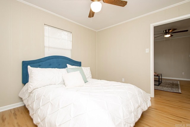 bedroom with crown molding, light wood-type flooring, and ceiling fan