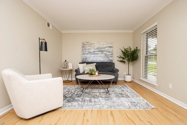 living room featuring crown molding and light hardwood / wood-style flooring