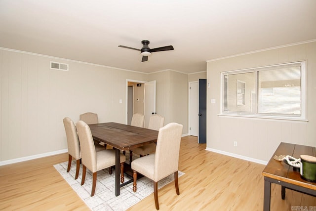 dining room with ornamental molding, light hardwood / wood-style flooring, and ceiling fan