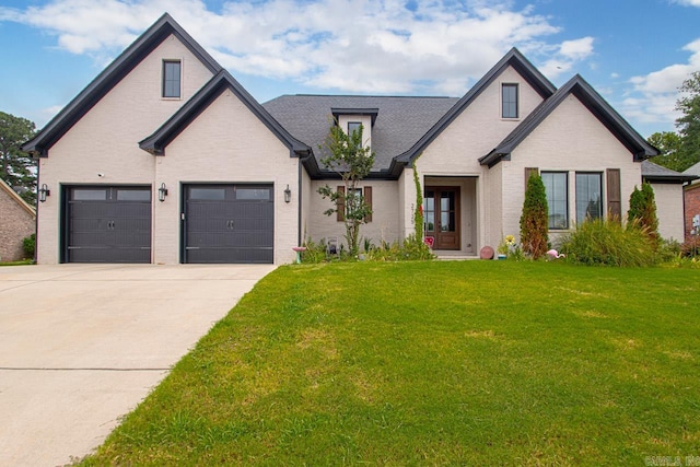 view of front of property featuring a garage and a front yard