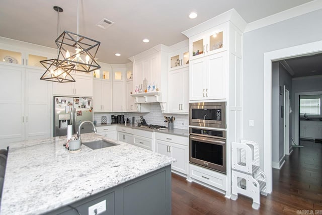 kitchen featuring tasteful backsplash, stainless steel appliances, sink, light stone counters, and dark hardwood / wood-style floors