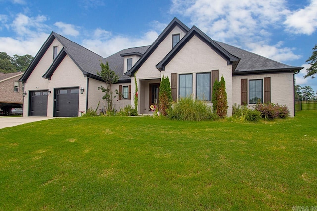 view of front of house featuring a garage and a front lawn