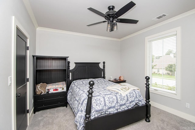 carpeted bedroom with ceiling fan and ornamental molding