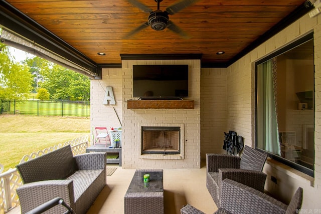 view of patio with an outdoor living space with a fireplace and ceiling fan