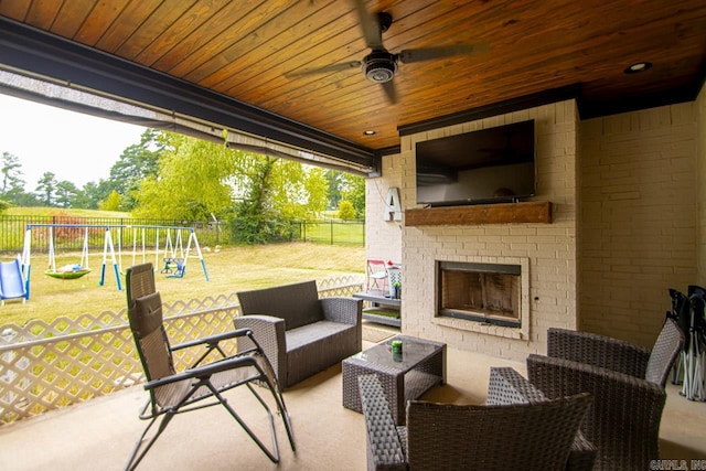 view of patio featuring an outdoor living space with a fireplace and a playground