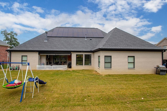 rear view of property with a yard