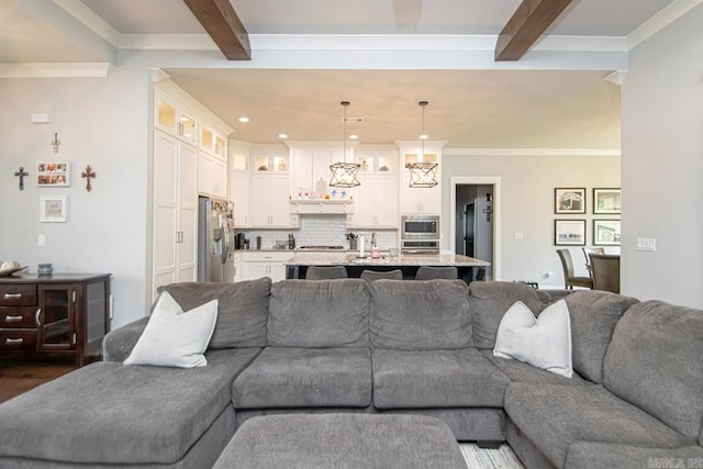 living room with beamed ceiling, crown molding, and dark hardwood / wood-style floors