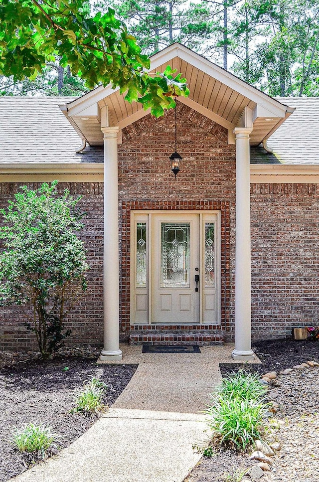 view of exterior entry with covered porch