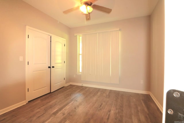 unfurnished bedroom with ceiling fan, hardwood / wood-style flooring, and a closet