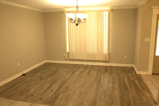 unfurnished room with a notable chandelier, crown molding, and hardwood / wood-style floors