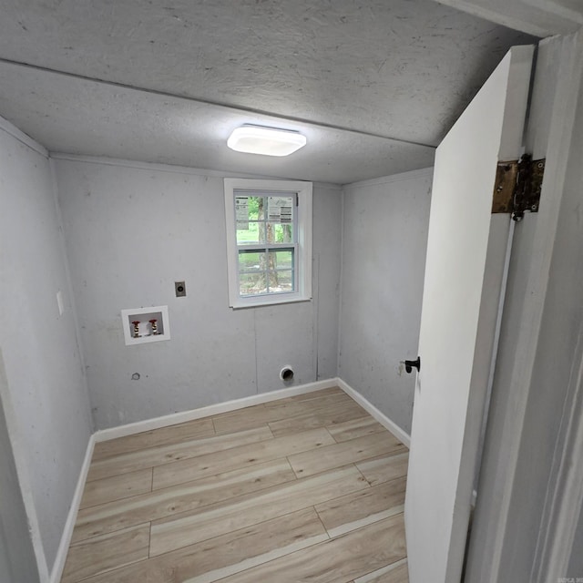 laundry room with light wood-type flooring, hookup for an electric dryer, washer hookup, and a textured ceiling