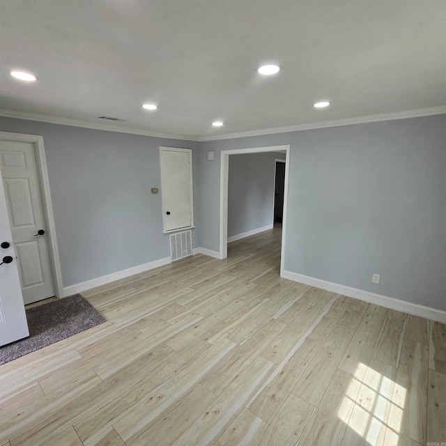 unfurnished room with light wood-type flooring and ornamental molding