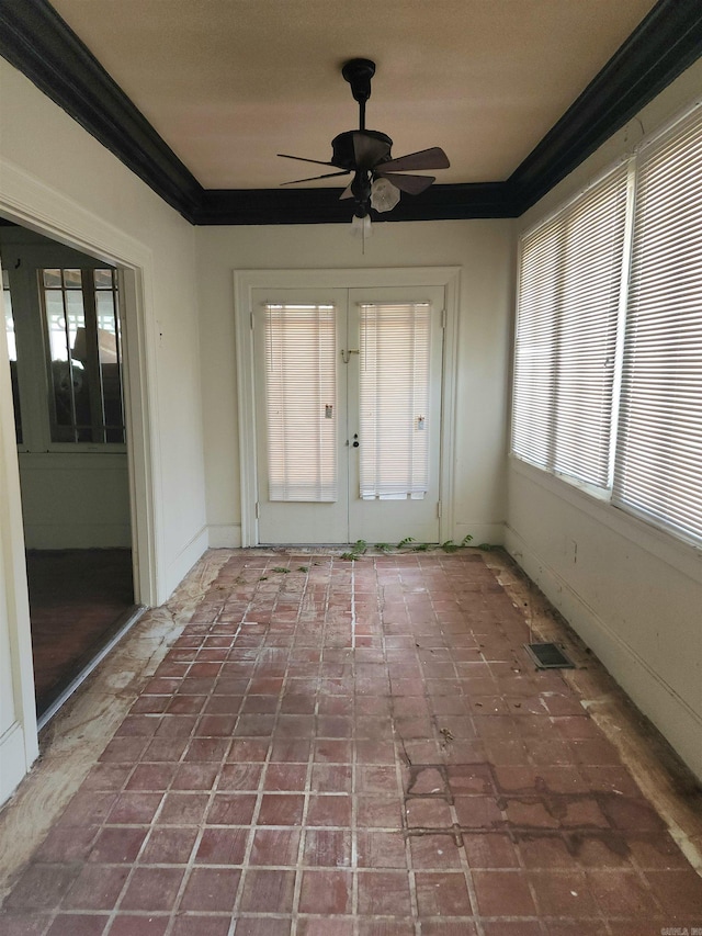 unfurnished sunroom featuring ceiling fan and french doors