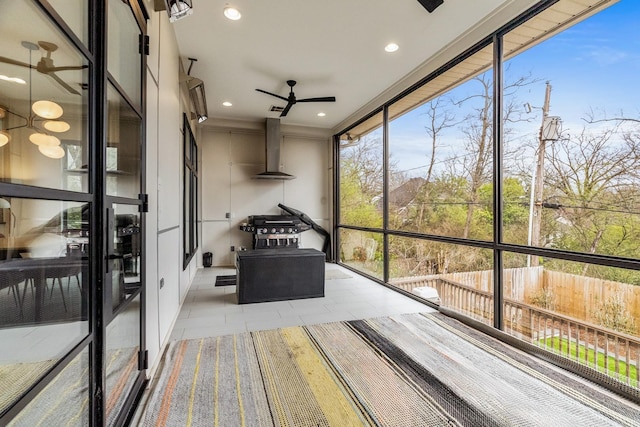 unfurnished sunroom featuring a wealth of natural light and ceiling fan