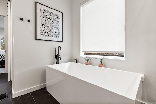 bathroom featuring a wealth of natural light and tile patterned flooring