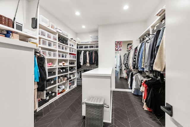 spacious closet featuring dark tile patterned flooring