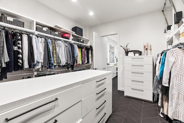 walk in closet with dark tile patterned floors