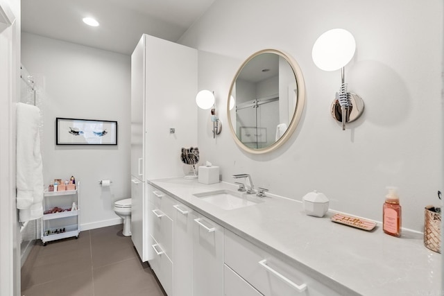 bathroom featuring vanity, toilet, and tile patterned floors