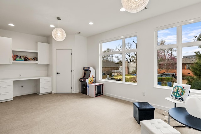 sitting room with light carpet and built in desk