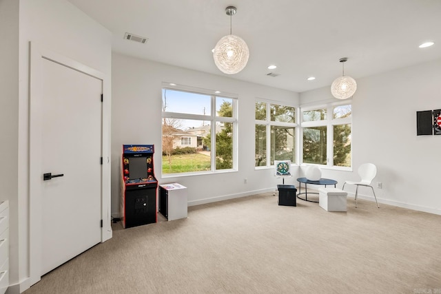 living area with light colored carpet and plenty of natural light