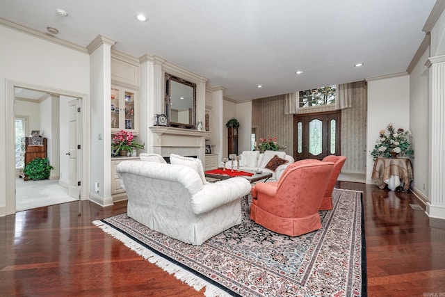 living room featuring crown molding, baseboards, dark wood finished floors, recessed lighting, and a fireplace