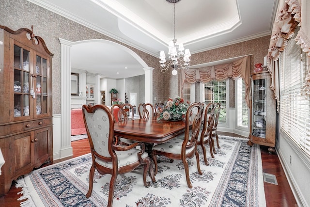 dining room featuring visible vents, crown molding, and wallpapered walls