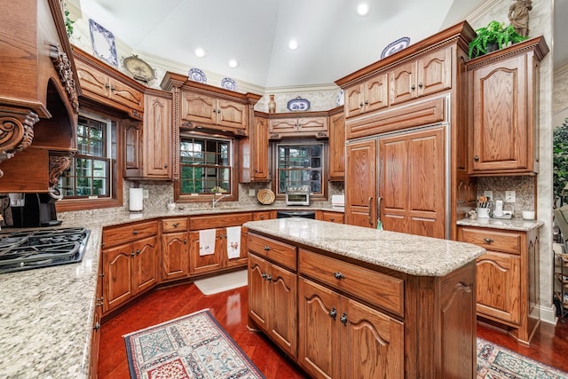 kitchen with a wealth of natural light, black gas stovetop, dark wood-type flooring, and vaulted ceiling