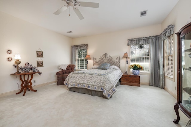 carpeted bedroom with baseboards, visible vents, and ceiling fan