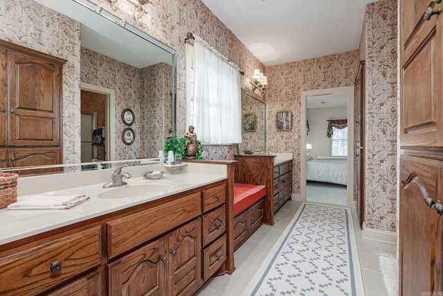 ensuite bathroom featuring ensuite bath, tile patterned flooring, wallpapered walls, and vanity