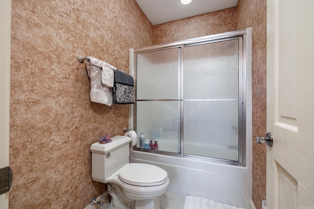 full bath featuring shower / bath combination with glass door and toilet