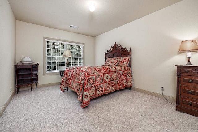 bedroom with visible vents, baseboards, and carpet flooring