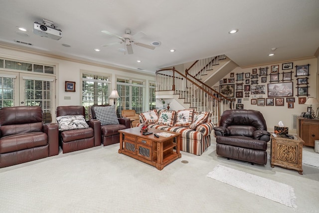 carpeted living room with recessed lighting, visible vents, crown molding, and stairway