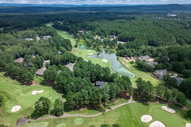 bird's eye view with view of golf course, a forest view, and a water view