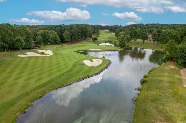 bird's eye view featuring a water view, view of golf course, and a wooded view