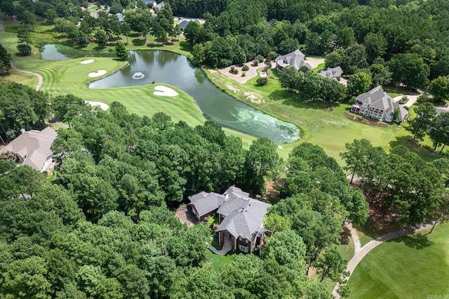 drone / aerial view with view of golf course and a water view