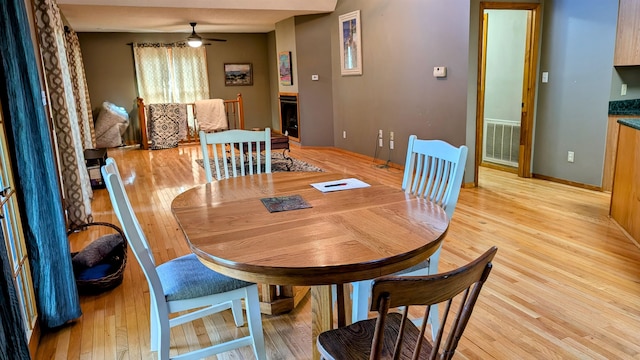 dining area featuring light hardwood / wood-style floors and ceiling fan