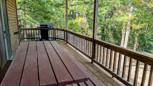 wooden terrace featuring a grill