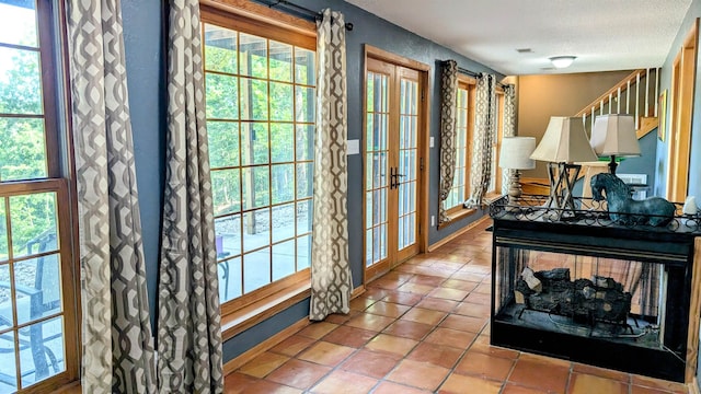 doorway to outside featuring a healthy amount of sunlight and light tile patterned floors