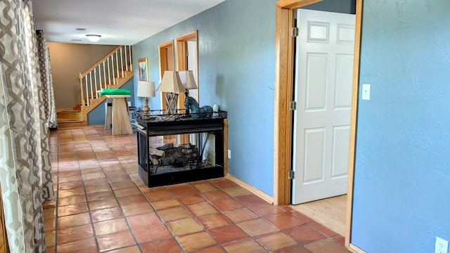 hallway featuring tile patterned flooring