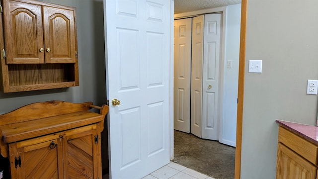 bathroom with tile patterned floors and a textured ceiling