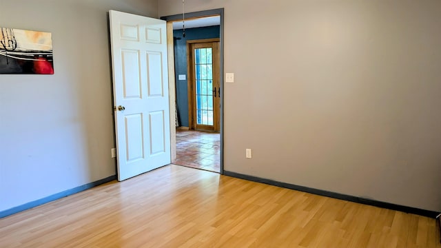 unfurnished room with light wood-type flooring