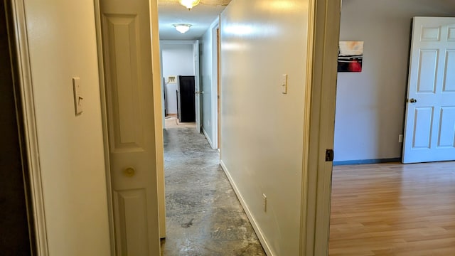 hallway with a textured ceiling