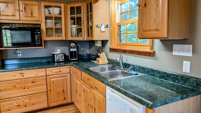 kitchen with sink, light wood-type flooring, black microwave, and white dishwasher