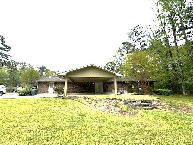 single story home with a carport and a front yard