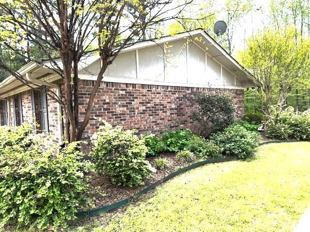 view of home's exterior with a yard