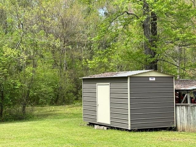 view of outbuilding featuring a yard