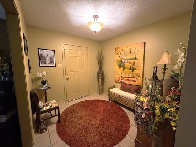 sitting room featuring a textured ceiling and light tile patterned flooring