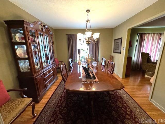 dining room with an inviting chandelier and light hardwood / wood-style flooring